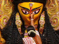 Married women offer their final prayer to Goddess Durga by presenting vermillion and sweets before the immersion of Durga idols on the last...