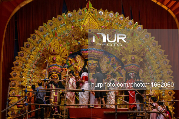 Married women offer their final prayer to Goddess Durga by presenting vermillion and sweets before the immersion of Durga idols on the last...