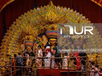 Married women offer their final prayer to Goddess Durga by presenting vermillion and sweets before the immersion of Durga idols on the last...