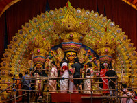 Married women offer their final prayer to Goddess Durga by presenting vermillion and sweets before the immersion of Durga idols on the last...