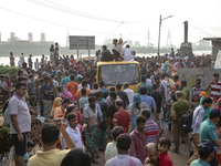 Bangladeshi Hindu devotees gather to immerse an idol of their deity Durga into the Buriganga River during celebrations on the last day of th...