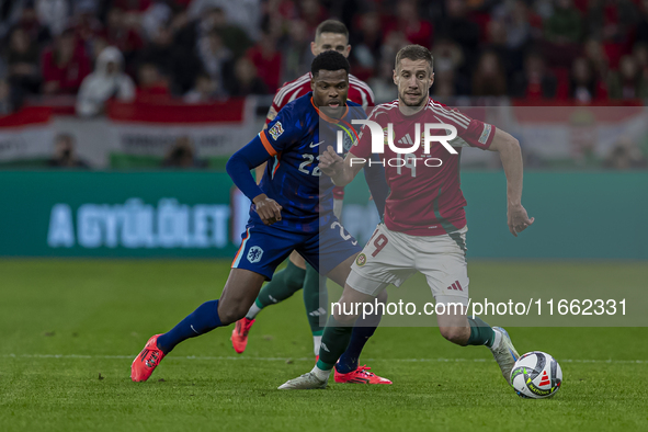 Barnabas Varga of Hungary competes for the ball with Denzel Dumfries of the Netherlands during the UEFA Nations League Group match at Puskas...