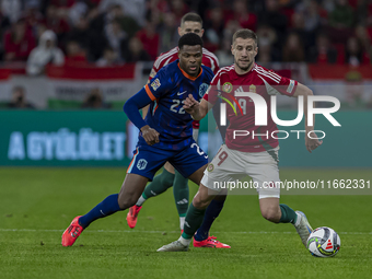 Barnabas Varga of Hungary competes for the ball with Denzel Dumfries of the Netherlands during the UEFA Nations League Group match at Puskas...