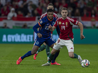 Barnabas Varga of Hungary competes for the ball with Denzel Dumfries of the Netherlands during the UEFA Nations League Group match at Puskas...