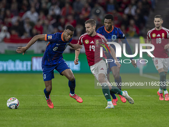 Barnabas Varga of Hungary competes for the ball with Denzel Dumfries of the Netherlands during the UEFA Nations League Group match at Puskas...