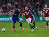 Barnabas Varga of Hungary competes for the ball with Denzel Dumfries of the Netherlands during the UEFA Nations League Group match at Puskas...