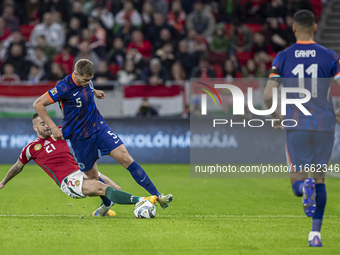 Micky van de Ven of the Netherlands competes for the ball with Endre Botka of Hungary during the UEFA Nations League Group match at Puskas A...