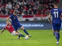 Micky van de Ven of the Netherlands competes for the ball with Endre Botka of Hungary during the UEFA Nations League Group match at Puskas A...