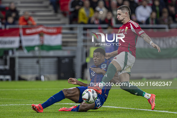 Zsolt Nagy of Hungary competes for the ball with Denzel Dumfries of the Netherlands during the UEFA Nations League Group match at Puskas Are...