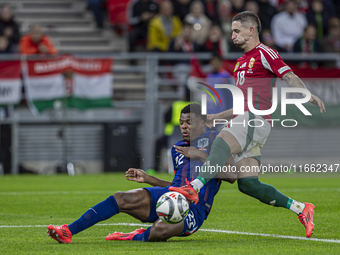 Zsolt Nagy of Hungary competes for the ball with Denzel Dumfries of the Netherlands during the UEFA Nations League Group match at Puskas Are...