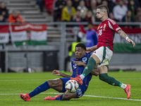 Zsolt Nagy of Hungary competes for the ball with Denzel Dumfries of the Netherlands during the UEFA Nations League Group match at Puskas Are...