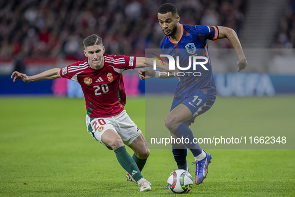 Roland Sallai of Hungary competes for the ball with Cody Gakpo of the Netherlands during the UEFA Nations League Group match at Puskas Arena...