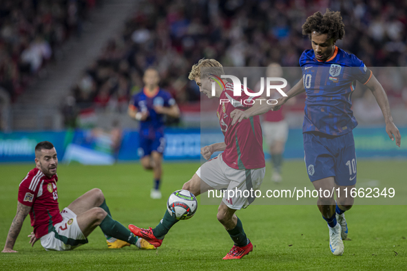 Andras Schafer of Hungary competes for the ball with Joshua Zirkzee of the Netherlands during the UEFA Nations League Group match at Puskas...