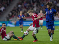 Andras Schafer of Hungary competes for the ball with Joshua Zirkzee of the Netherlands during the UEFA Nations League Group match at Puskas...