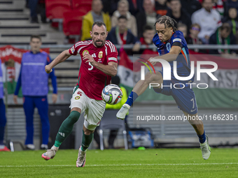 Xavi Simons of the Netherlands competes for the ball with Attila Fiola of Hungary during the UEFA Nations League Group match at Puskas Arena...