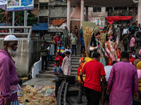 Bangladeshi Hindu devotees immerse an idol of their deity Durga into the Buriganga River during the last day of the Durga Puja, the largest...