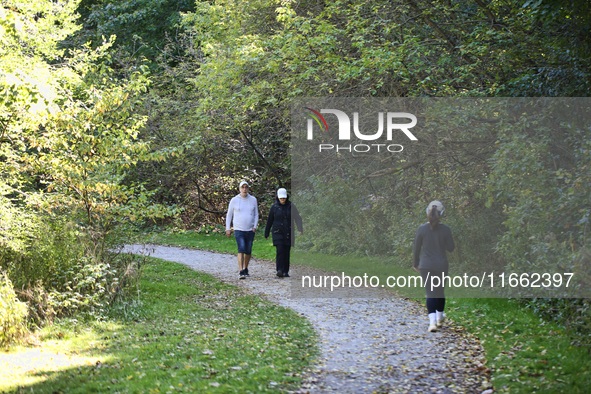 People walk along a forest trail in Markham, Ontario, Canada, on October 12, 2024. 