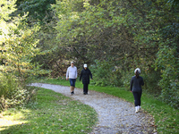 People walk along a forest trail in Markham, Ontario, Canada, on October 12, 2024. (