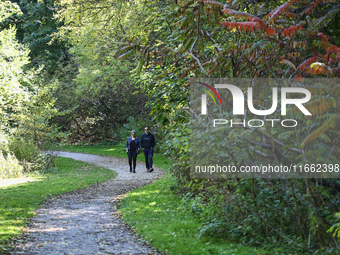 People walk along a forest trail in Markham, Ontario, Canada, on October 12, 2024. (