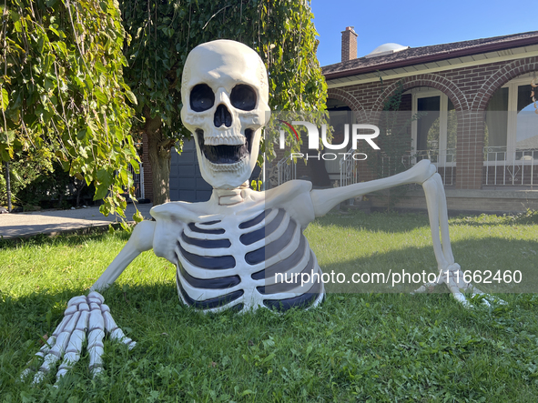 A giant skeleton stands outside a house in preparation for Halloween in Markham, Ontario, Canada, on October 12, 2024. 