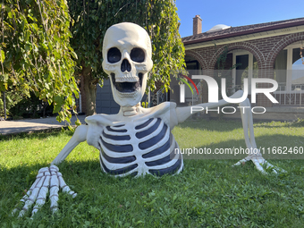 A giant skeleton stands outside a house in preparation for Halloween in Markham, Ontario, Canada, on October 12, 2024. (