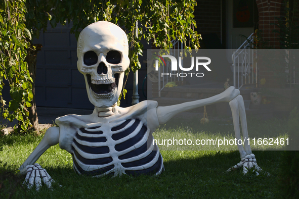 A giant skeleton stands outside a house in preparation for Halloween in Markham, Ontario, Canada, on October 12, 2024. 