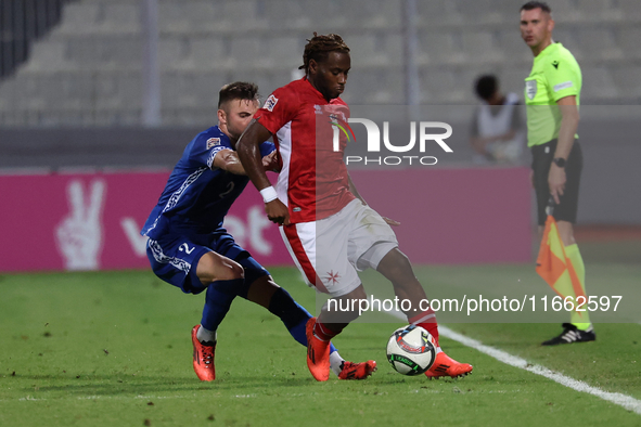 Joseph Mbong of Malta is closely followed by Oleg Reabciuk of Moldova during the UEFA Nations League, League D, Group D2 soccer match betwee...