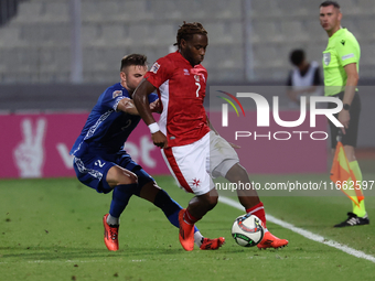 Joseph Mbong of Malta is closely followed by Oleg Reabciuk of Moldova during the UEFA Nations League, League D, Group D2 soccer match betwee...