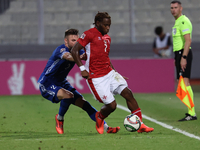 Joseph Mbong of Malta is closely followed by Oleg Reabciuk of Moldova during the UEFA Nations League, League D, Group D2 soccer match betwee...