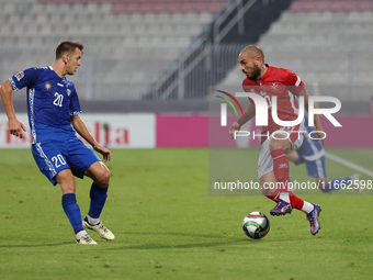 Teddy Teuma of Malta is closely followed by Sergiu Platica of Moldova during the UEFA Nations League, League D, Group D2 soccer match betwee...