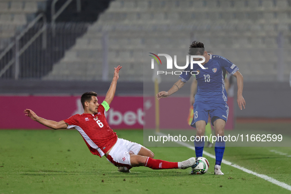 In Ta' Qali, Malta, on October 13, 2024, Maxim Cojocaru of Moldova is challenged by Matthew Guillaumier of Malta during the UEFA Nations Lea...