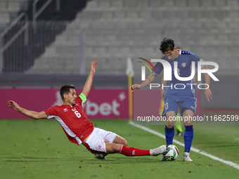 In Ta' Qali, Malta, on October 13, 2024, Maxim Cojocaru of Moldova is challenged by Matthew Guillaumier of Malta during the UEFA Nations Lea...