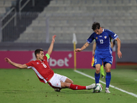 In Ta' Qali, Malta, on October 13, 2024, Maxim Cojocaru of Moldova is challenged by Matthew Guillaumier of Malta during the UEFA Nations Lea...