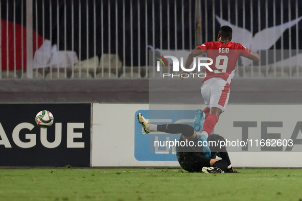 In Ta' Qali, Malta, on October 13, 2024, Kemar Reid of Malta is fouled by Dumitru Celeadnic, the goalkeeper of Moldova, resulting in a penal...