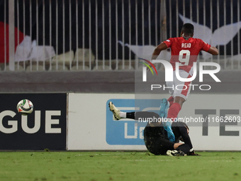 In Ta' Qali, Malta, on October 13, 2024, Kemar Reid of Malta is fouled by Dumitru Celeadnic, the goalkeeper of Moldova, resulting in a penal...