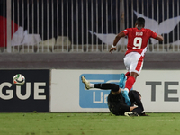 In Ta' Qali, Malta, on October 13, 2024, Kemar Reid of Malta is fouled by Dumitru Celeadnic, the goalkeeper of Moldova, resulting in a penal...