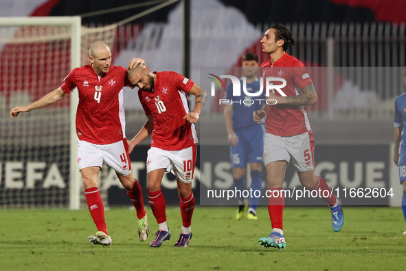 In Ta' Qali, Malta, on October 13, 2024, Teddy Teuma of Malta is congratulated by teammate Gabriel Mentz after scoring the 1-0 goal for Malt...