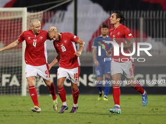 In Ta' Qali, Malta, on October 13, 2024, Teddy Teuma of Malta is congratulated by teammate Gabriel Mentz after scoring the 1-0 goal for Malt...