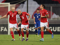 In Ta' Qali, Malta, on October 13, 2024, Teddy Teuma of Malta is congratulated by teammate Gabriel Mentz after scoring the 1-0 goal for Malt...