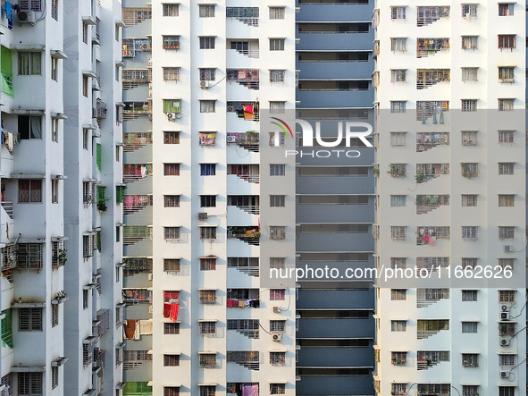 Residents of a high-rise residential building appear in Kolkata, India, on October 11, 2024. 