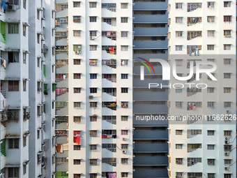 Residents of a high-rise residential building appear in Kolkata, India, on October 11, 2024. (