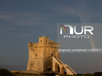 The comet Tsuchinshan-ATLAS (C/2023 A3) is seen over Torre Squillace, near Lecce, Italy, on October 13, 2024. The comet's coma, or head, mea...