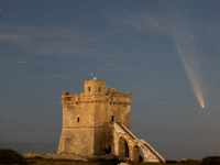 The comet Tsuchinshan-ATLAS (C/2023 A3) is seen over Torre Squillace, near Lecce, Italy, on October 13, 2024. The comet's coma, or head, mea...