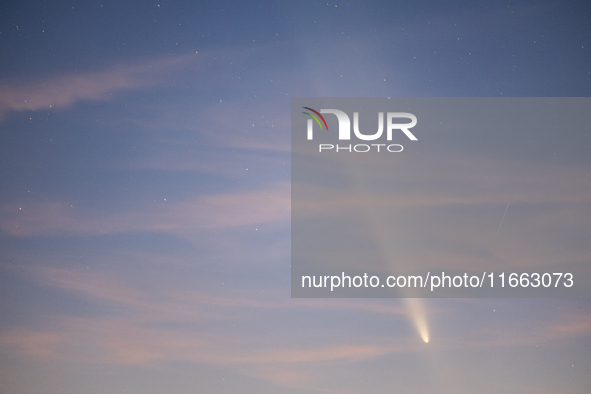 The comet Tsuchinshan-ATLAS (C/2023 A3) is seen over Torre Squillace, near Lecce, Italy, on October 13, 2024. The comet's coma, or head, mea...