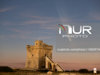 The comet Tsuchinshan-ATLAS (C/2023 A3) is seen over Torre Squillace, near Lecce, Italy, on October 13, 2024. The comet's coma, or head, mea...