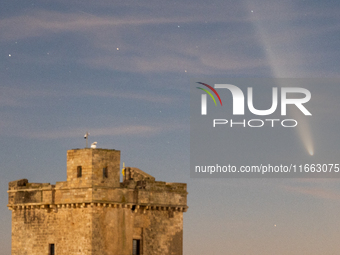 The comet Tsuchinshan-ATLAS (C/2023 A3) is seen over Torre Squillace, near Lecce, Italy, on October 13, 2024. The comet's coma, or head, mea...