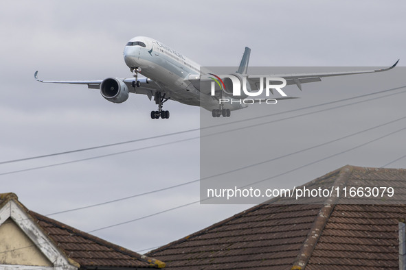 Cathay Pacific Airbus A350-900 passenger aircraft spotted flying over the houses in Myrtle Avenue before landing at London Heathrow Airport...