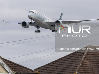 Cathay Pacific Airbus A350-900 passenger aircraft spotted flying over the houses in Myrtle Avenue before landing at London Heathrow Airport...