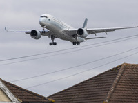 Cathay Pacific Airbus A350-900 passenger aircraft spotted flying over the houses in Myrtle Avenue before landing at London Heathrow Airport...