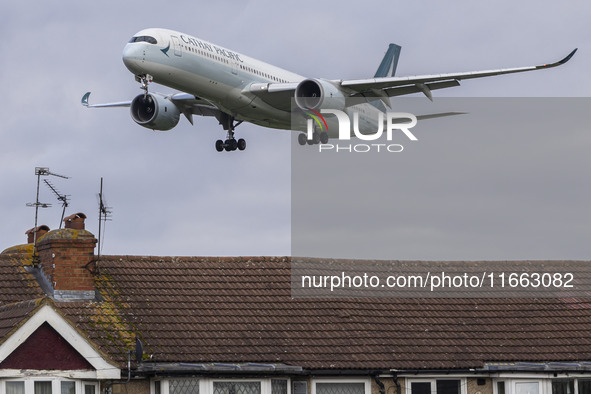 Cathay Pacific Airbus A350-900 passenger aircraft spotted flying over the houses in Myrtle Avenue before landing at London Heathrow Airport...